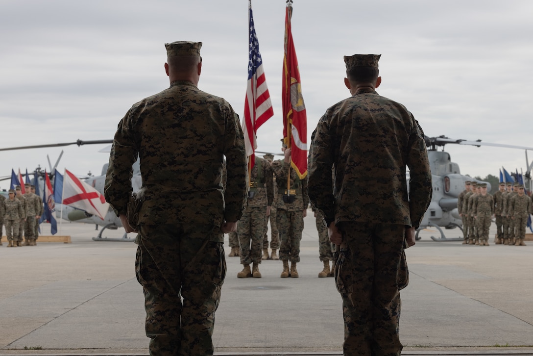 U.S. Marine Corps Master Gunnery Sgt. Lawrence Reeve Jr. (left), a maintenance chief with Marine Light Attack Helicopter Squadron (HMLA) 269, and Lt. Col. Ralph Tompkins, commanding officer of HMLA-269, stand at attention during a deactivation ceremony at Marine Corps Air Station New River, North Carolina, Dec. 9, 2022. HMLA-269 deactivated in accordance with Force Design 2030 after 51 years of service. HMLA-269 was a subordinate unit of 2nd Marine Aircraft Wing, the aviation combat element of II Marine Expeditionary Force. (U.S. Marine Corps photo by Lance Cpl. Orlanys Diaz Figueroa)