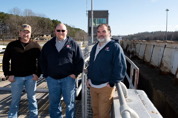 (Left to Right) Owen Traughber, Joseph Traughber, and Jacob Traughber pose together Dec. 12, 2022, at Cheatham Lock on the Cumberland River in Ashland City, Tennessee. All three have served more than 20 years with the U.S. Army Corps of Engineers Nashville District in career fields that support navigation. (USACE Photo by Lee Roberts)