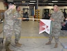 Col. Deon Maxwell, right, commander of the U.S. Army Medical Materiel Center-Europe, attaches an Army Safety Excellence Streamer to the USAMMC-E HHD unit colors during a ceremony Nov. 18 at Kaiserslautern Army Depot, Germany. The center recently earned the streamer for its strong safety culture, including 12 consecutive incident-free months and 100% participation in required risk management training among its personnel.