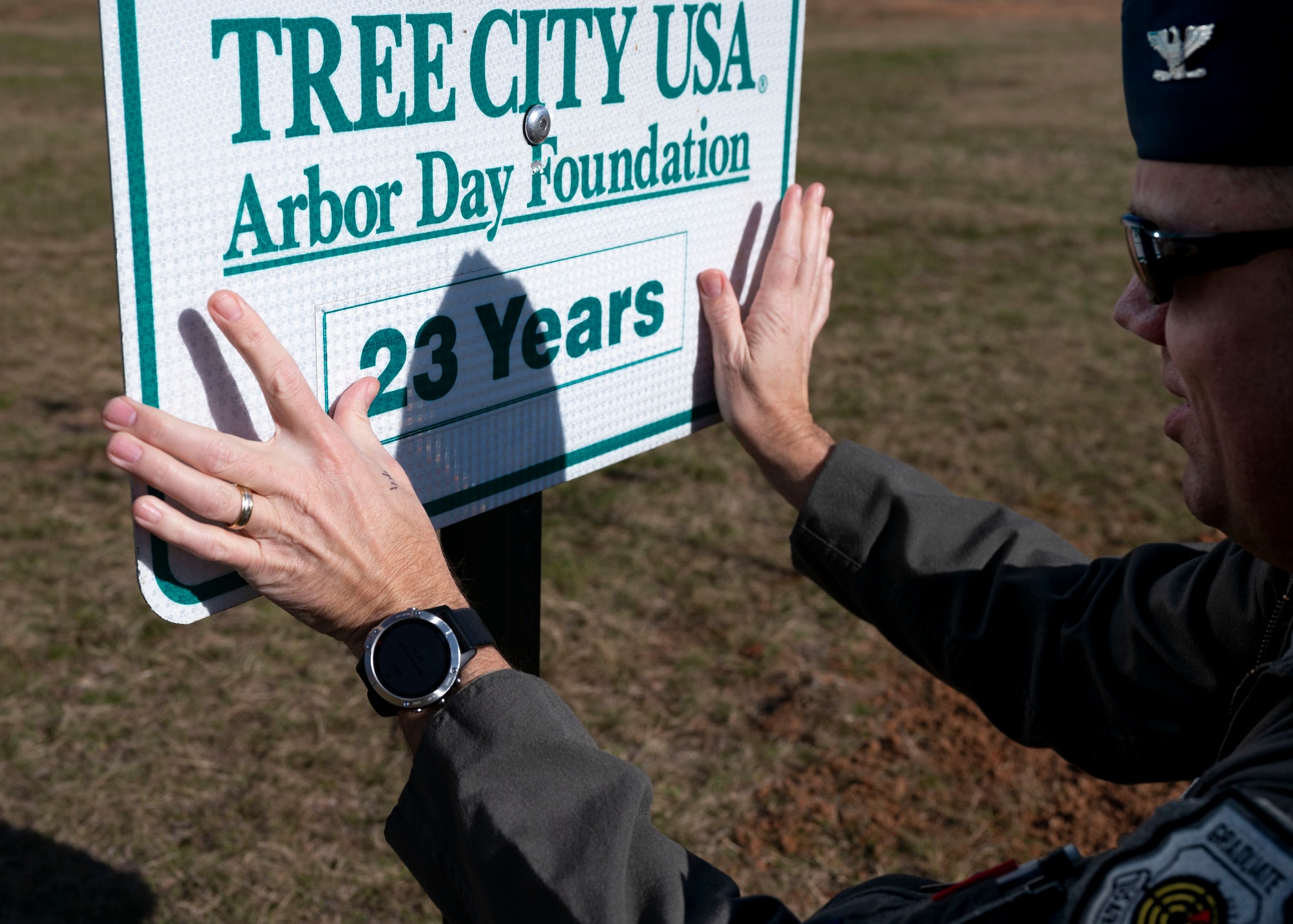 20th Fighter Wing Col. updates the Tree City USA sign to show 23 years.