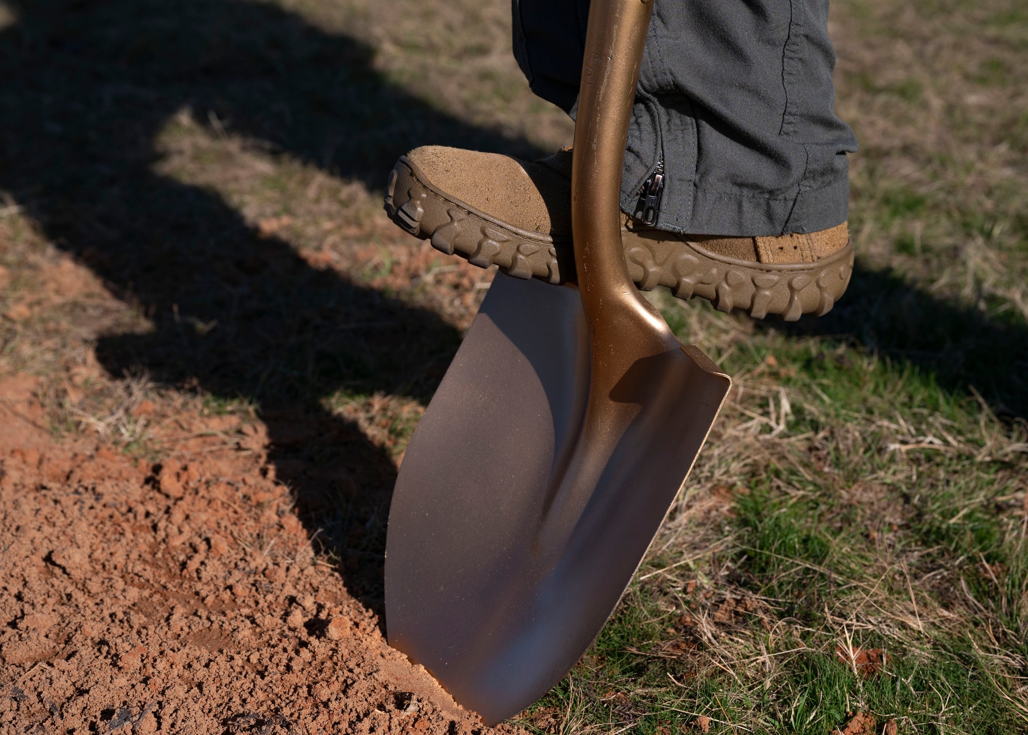 20th Fighter Wing Col. stands on shovel during an Arbor Day ceremony