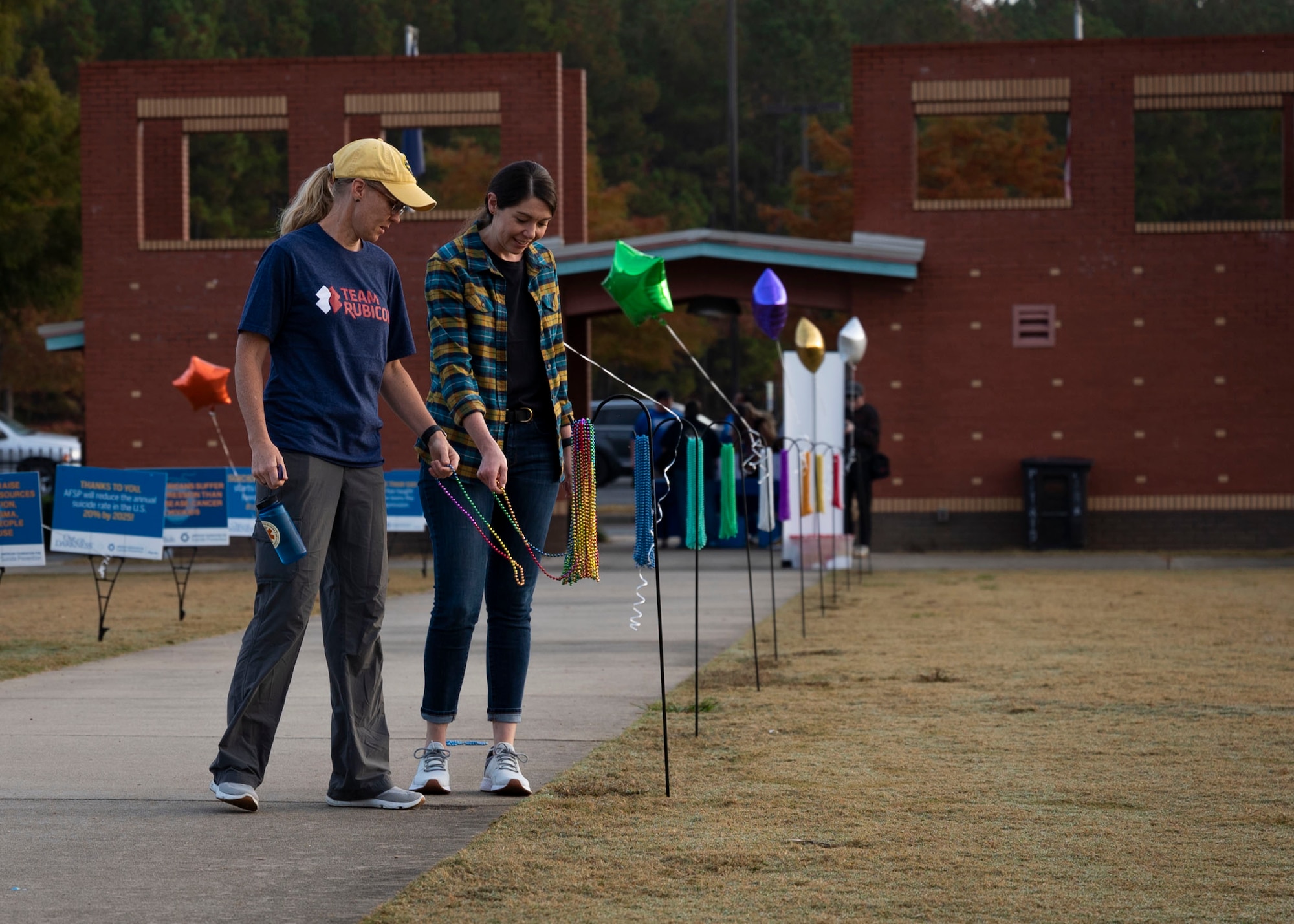 Out of the Darkness walk participants grab multi-colored beads