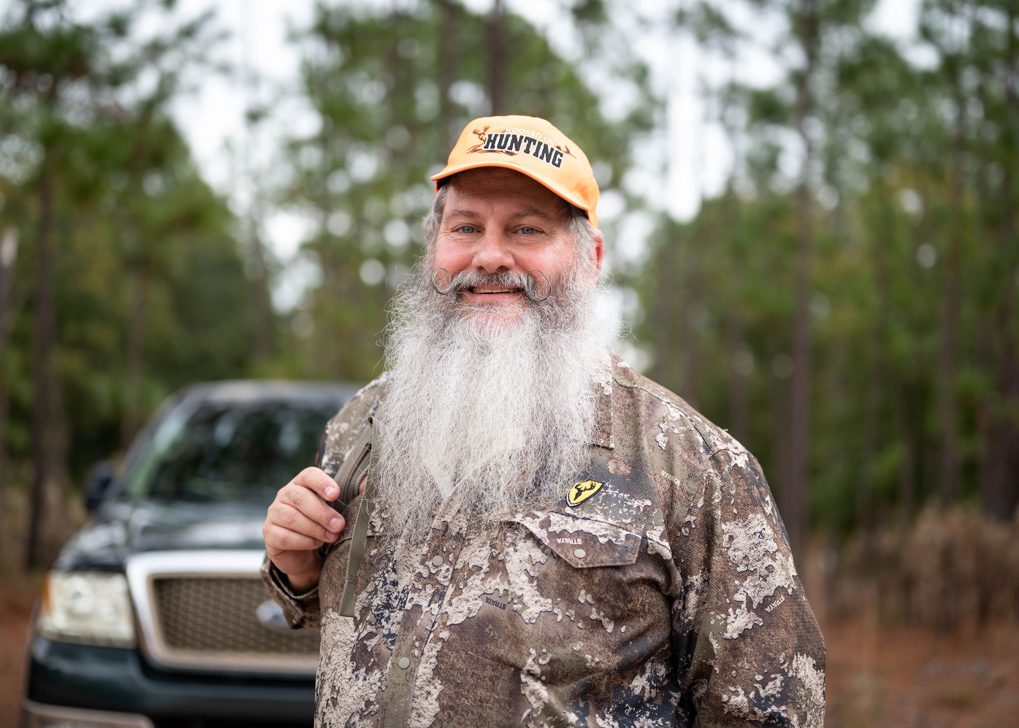 Christopher Tate, a volunteer huntmaster, poses for a portrait during a youth hunting event.