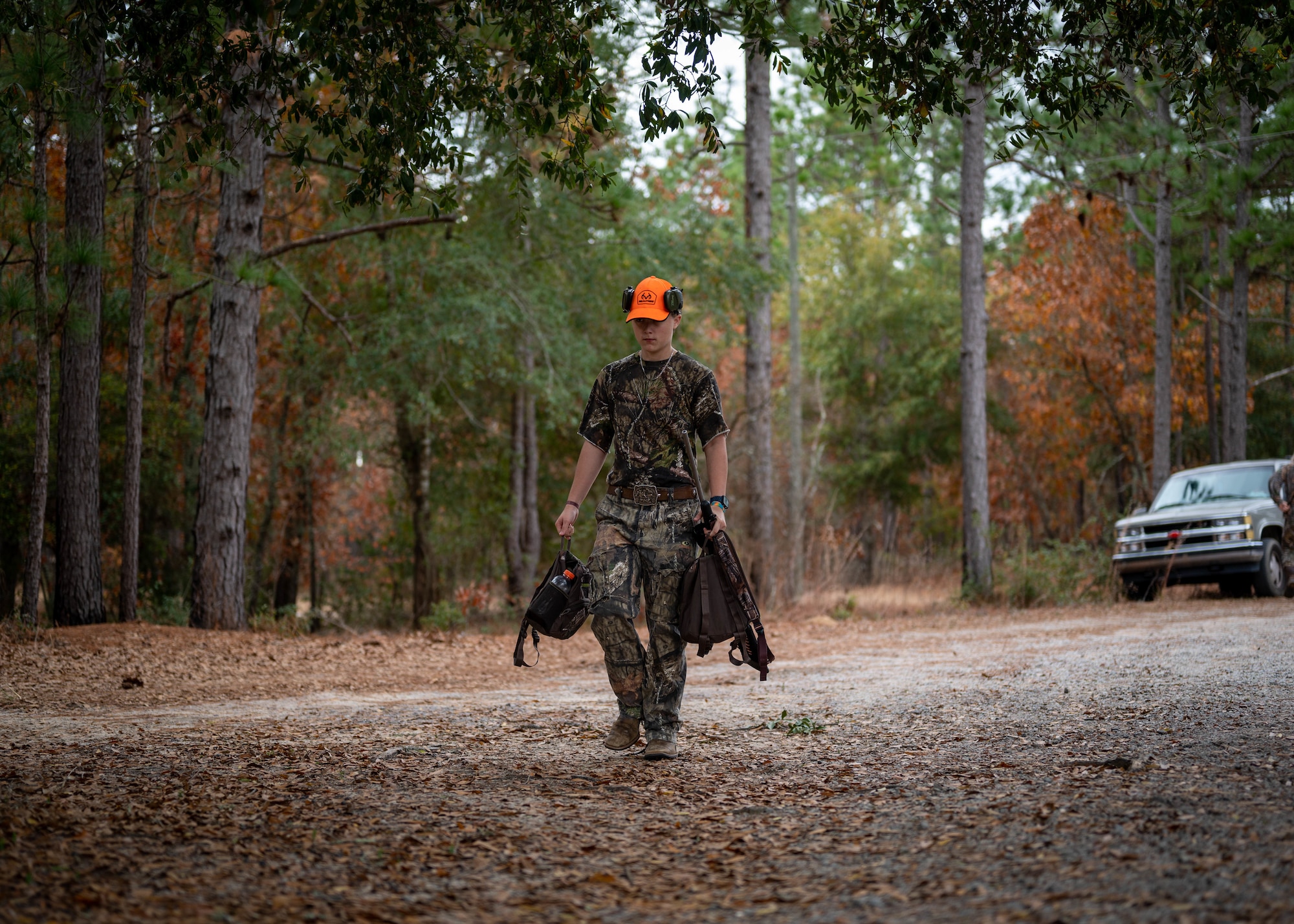 A youth hunting event participant gathers equipment before being escorted to a hunting stand.