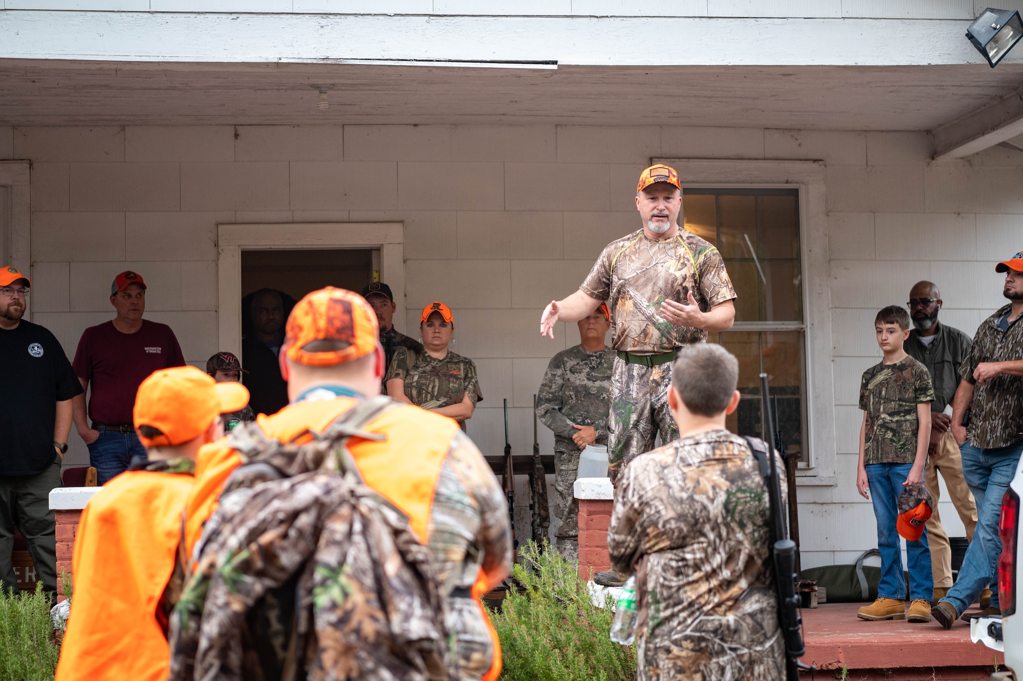 Mark Roy, a volunteer huntmaster, delivers a safety briefing to participants in a youth hunting event.