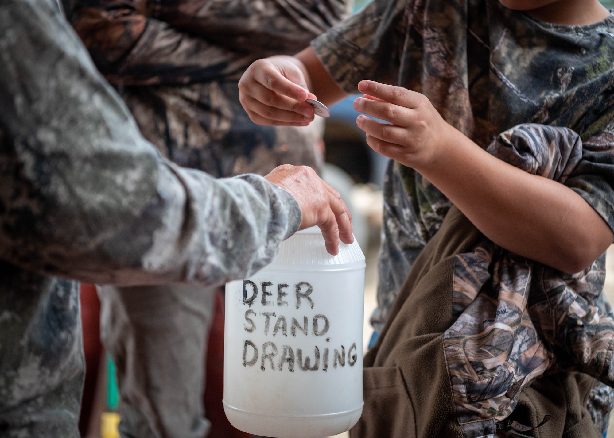 Participants in a youth hunting event draw ballots designating their hunting stand positions at Poinsett Electronic Combat Range.