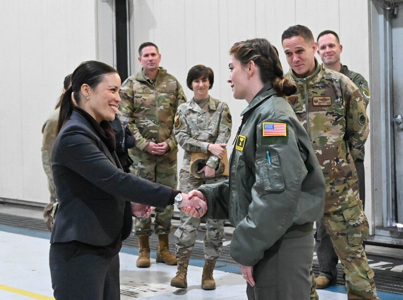 Under Secretary of the Air Force Gina Ortiz Jones coins a female Airman.