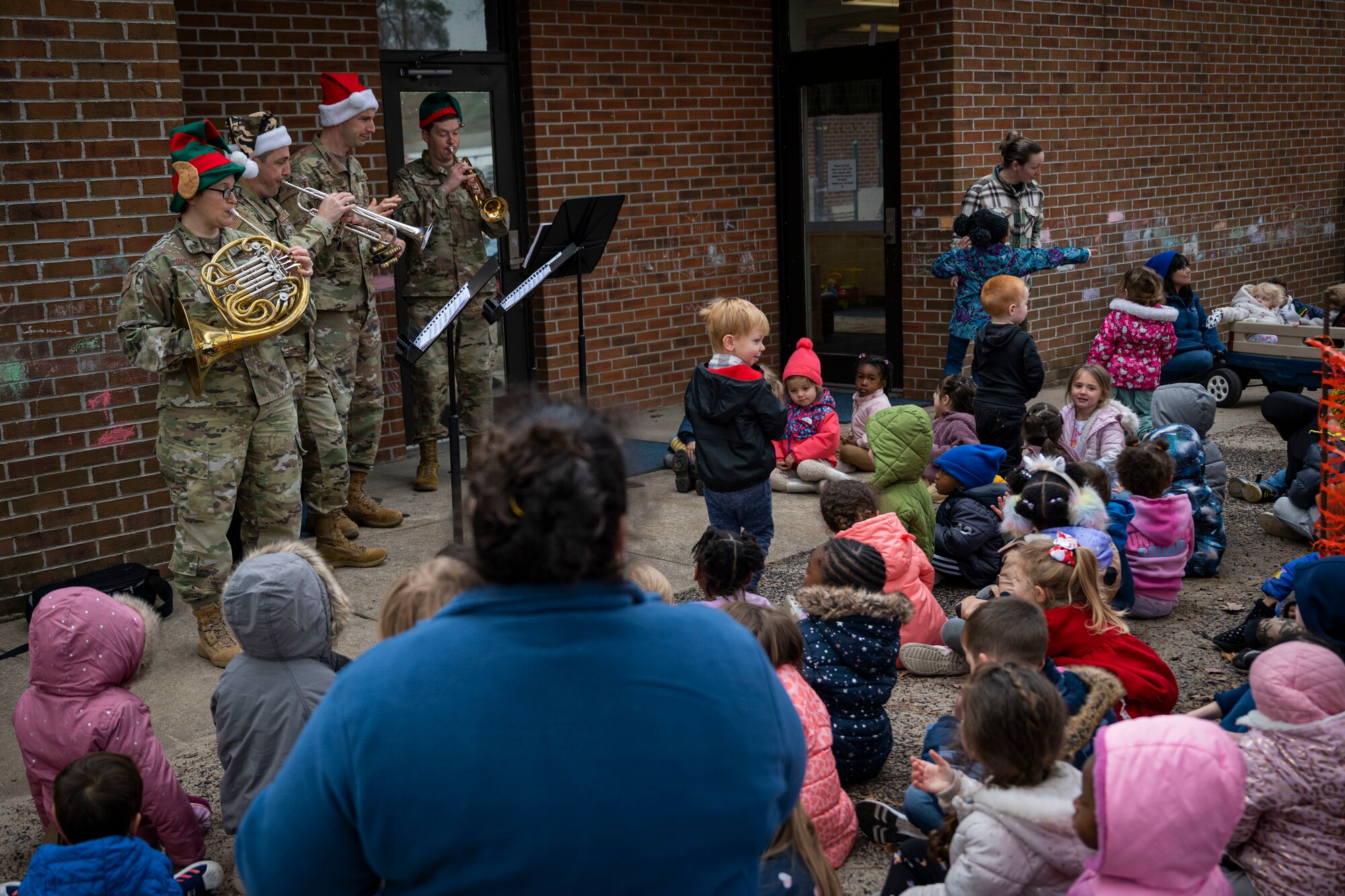 Members of the U.S. Air Force Heritage of America band brass quartet performs for children at the child development center at Seymour Johnson Air Force Base, North Carolina, Dec. 14, 2022. The band honors all who have served in the U.S. Armed Forces by commemorating the contributions of the nation's veterans; past and present, both at home and in deployed locations around the world.