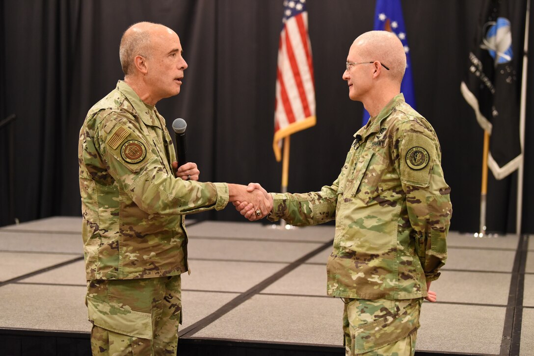 Image of two service members shaking hands.