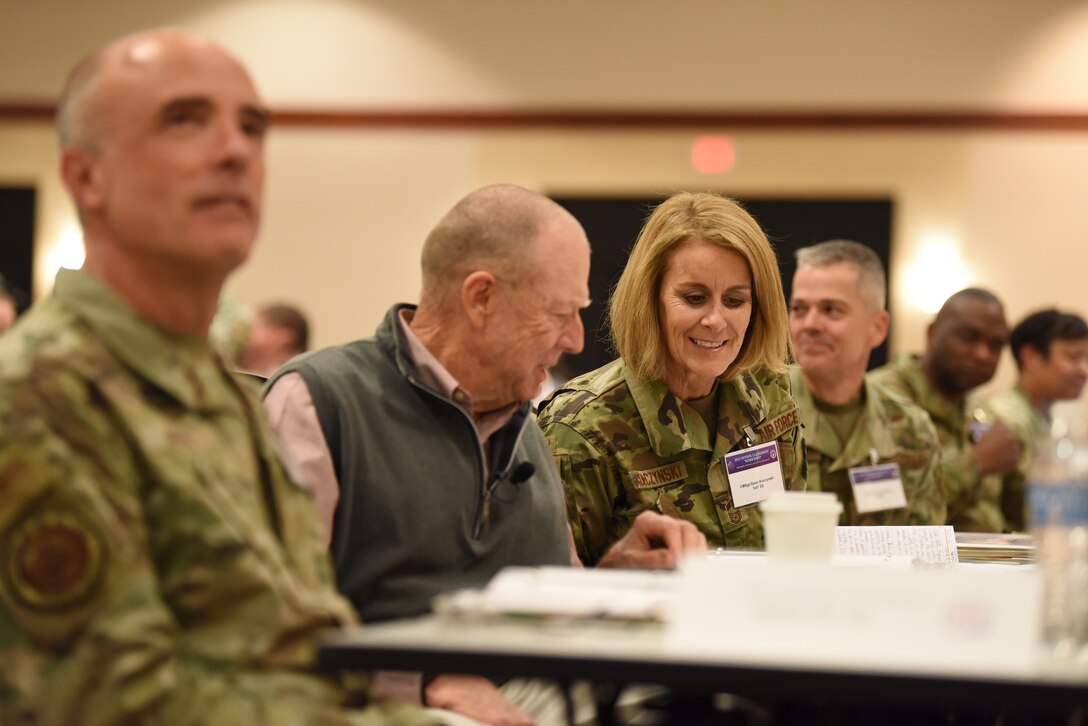 Image of Airmen talking at a table.