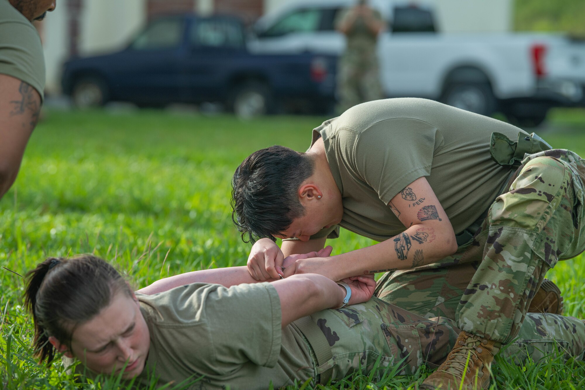 Defender tries to finish OC spray training course through the pain of being sprayed.