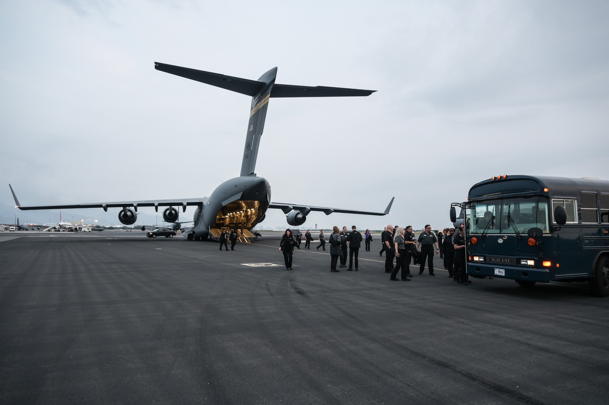 Executive Leadership Development Program participants board a bus on the flight line at Joint Base Pearl Harbor-Hickam, Hawaii, Dec. 6, 2022. Aircrew assigned to the 535th Airlift Squadron flew nearly 70 senior government officials on a C-17 Globemaster III for an orientation flight as part of their familiarization visit with the 15th Wing’s mission. (U.S. Air Force photo by Staff Sgt. Alan Ricker)
