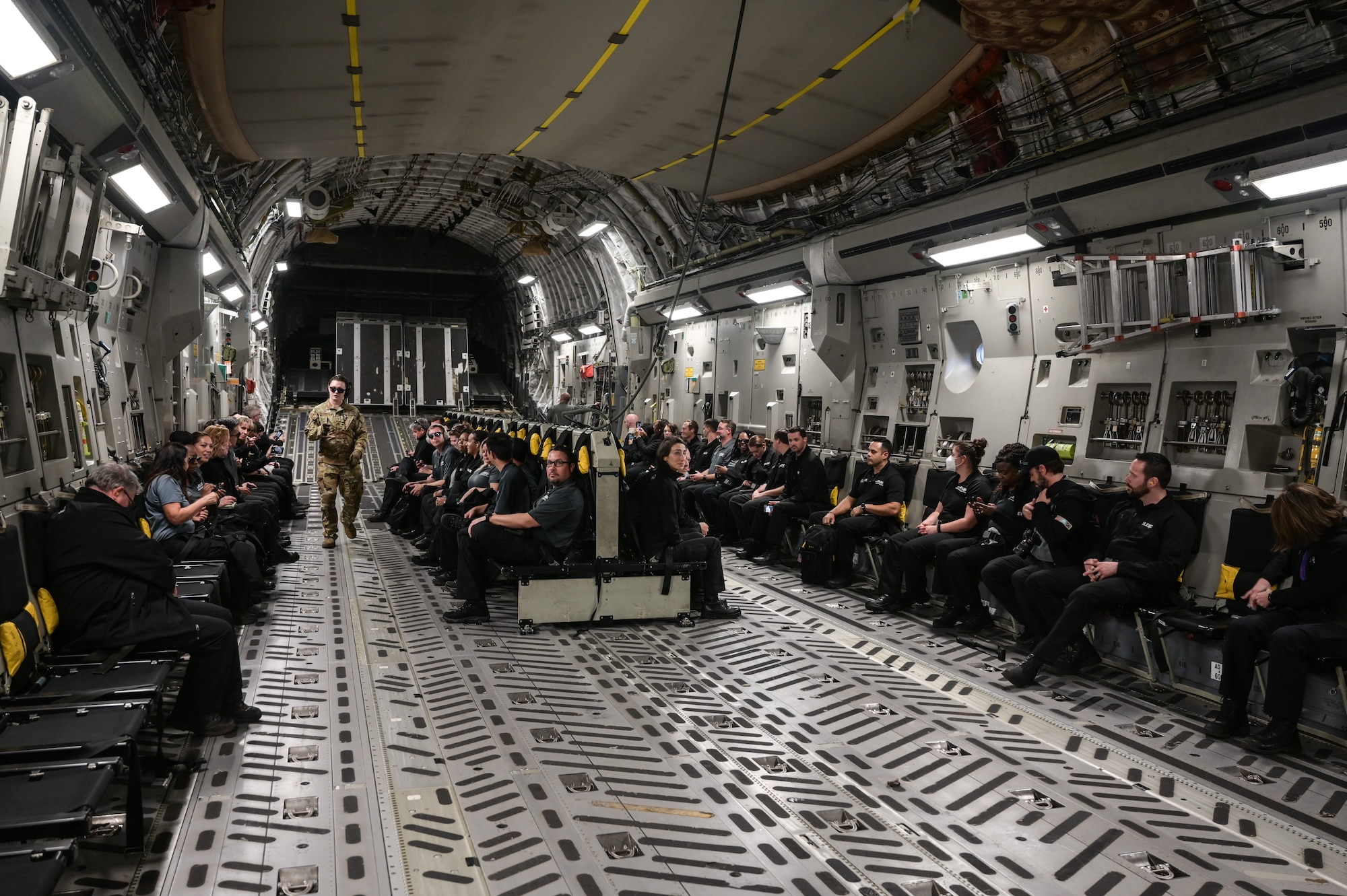 Executive Leadership Development Program participants sit inside of a C-17 Globemaster III fuselage at Joint Base Pearl Harbor-Hickam, Hawaii, Dec. 6, 2022. The 15th Wing was one of several military locations that ELDP participants visited, exposing them to various military operations. (U.S. Air Force photo by Staff Sgt. Alan Ricker)