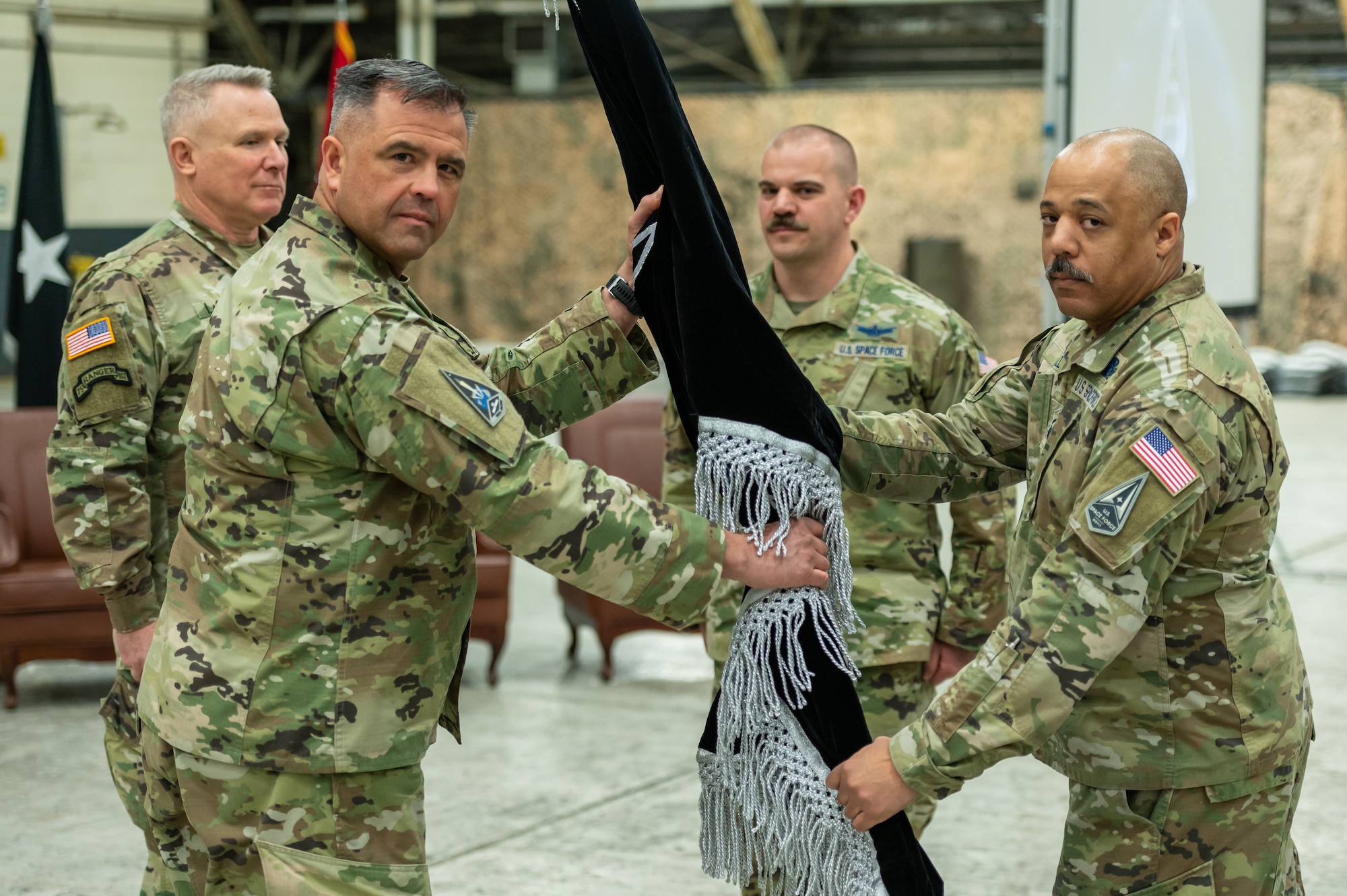 U.S. Space Force Brig. Gen. Anthony Mastalir, U.S. Space Forces Indo-Pacific Command commander, receives the U.S. Space Forces Korea guidon from USSF Master Sgt. Cederic Hill, USSFK senior enlisted leader, during an the unit’s activation ceremony at Osan Air Base, Republic of Korea, Dec. 14, 2022.