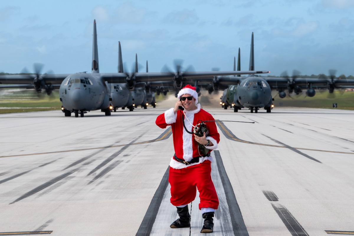 Santa communicates by radio with C-130 pilots on a runway
