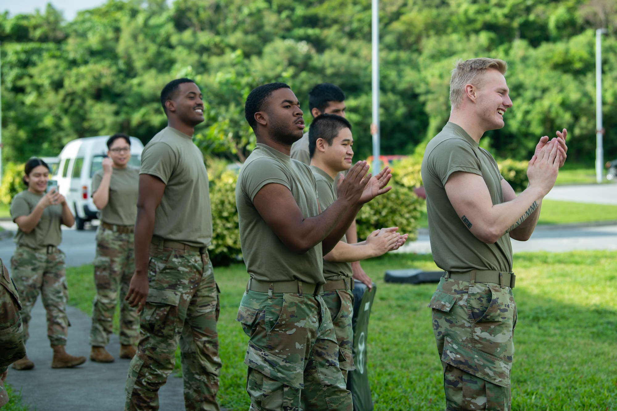 Security Forces Airmen clap for their teammate.