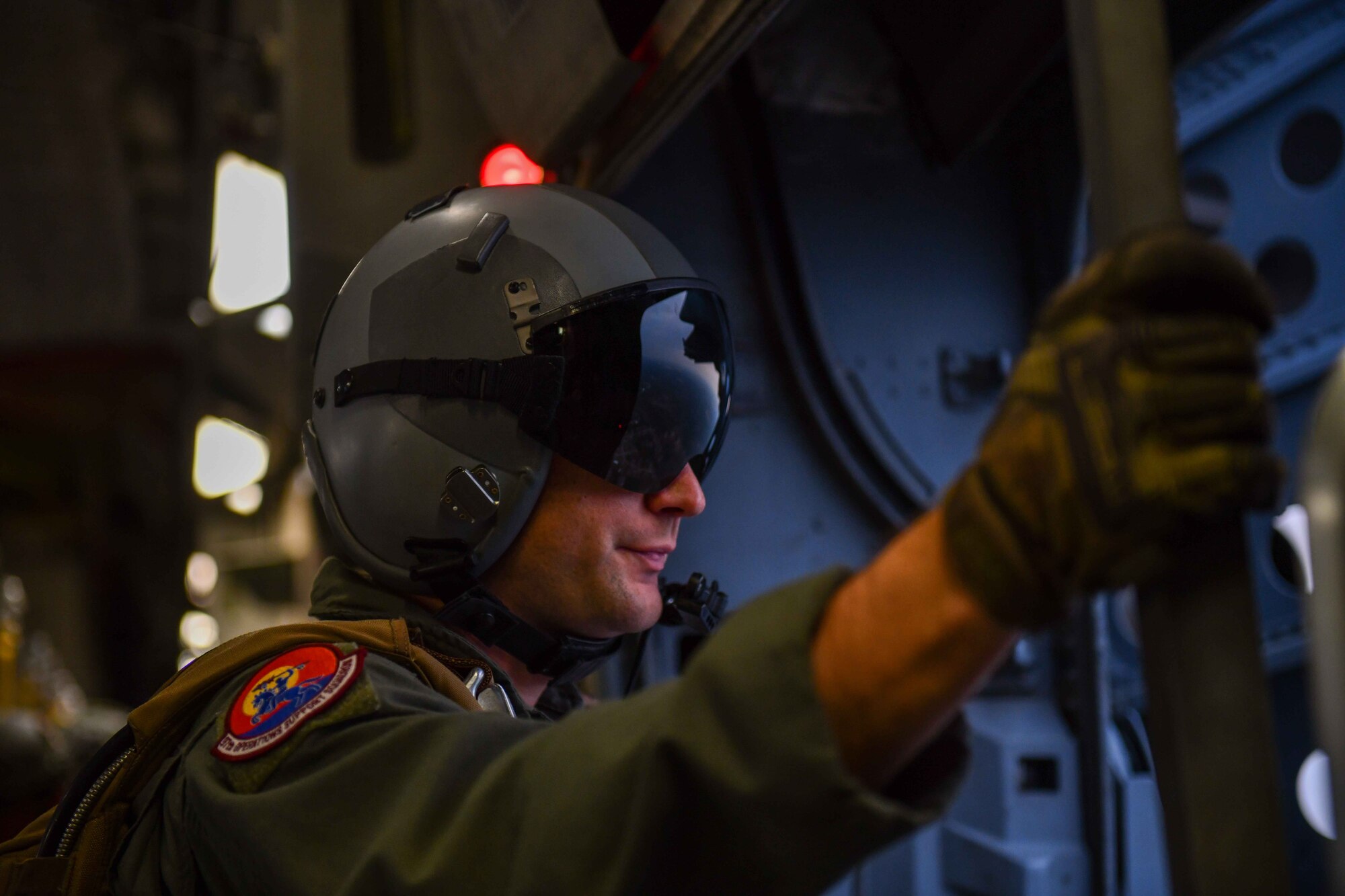 U.S. Air Force Staff Sgt. Stephen Spirlock, a 58th Airlift Squadron loadmaster from Altus Air Force Base, Oklahoma, looks out the door as it flies close to the Sicily Drop Zone near Fayetteville, North Carolina, Dec. 8, 2022. Operation Toy Drop lasted from Dec. 5-13, with aircrew from the 58th AS joining from Dec. 7-9. (U.S. Air Force photo by Airman 1st Class Kari Degraffenreed)