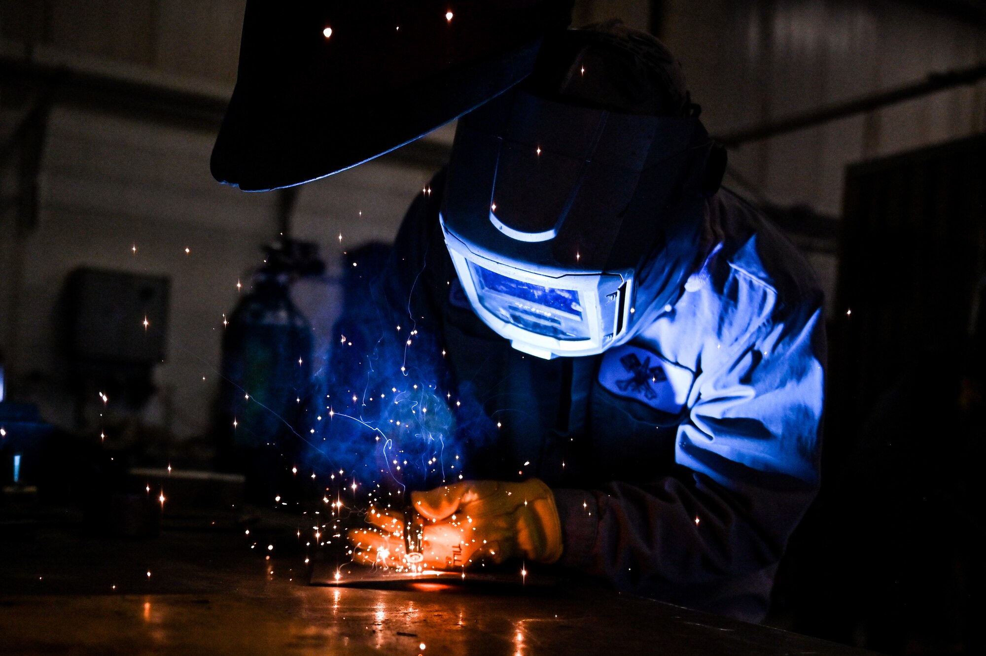 Orlando Cepeda, 90th Logistics Readiness Squadron mobile metal mechanic, welds a piece of metal on F.E. Warren Air Force Base, Wyoming, Nov. 29, 2022. With more than 40 years of experience, the 90 LRS Monster Garage or body shop team is repairing the 90th Missile Wing fleet while supporting the Air Force Global Strike priority of people by finding ways to train the next generation of Airmen and find innovative solutions. (U.S. Air Force photo by Joseph Coslett Jr.)