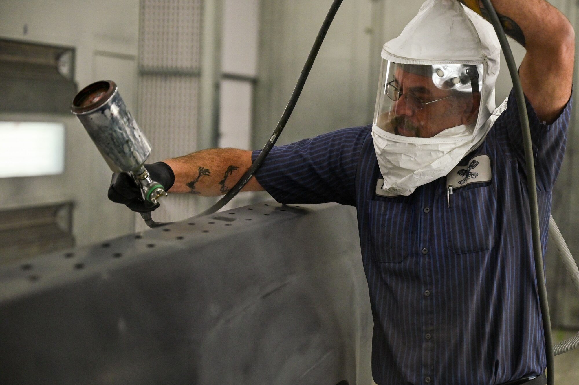 Thomas Hoadley, 90th Logistics Readiness Squadron mobile metal mechanic, applies sealant to a Ford truck rear panel on F.E. Warren Air Force Base, Wyoming, Nov. 29, 2022. With more than 40 years of experience, the 90 LRS Monster Garage or body shop team is repairing the 90th Missile Wing fleet while supporting the Air Force Global Strike priority of people by finding ways to train the next generation of Airmen and find innovative solutions. (U.S. Air Force photo by Joseph Coslett Jr.)