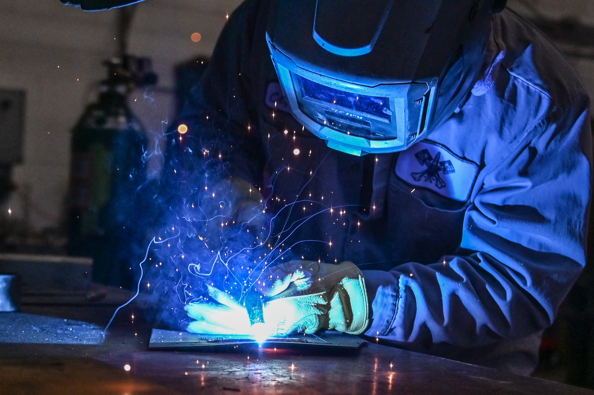 Orlando Cepeda, 90th Logistics Readiness Squadron mobile metal mechanic, welds a piece of metal on F.E. Warren Air Force Base, Wyoming, Nov. 29, 2022. With more than 40 years of experience, the 90 LRS Monster Garage or body shop team is repairing the 90th Missile Wing fleet while supporting the Air Force Global Strike priority of people by finding ways to train the next generation of Airmen and find innovative solutions. (U.S. Air Force photo by Joseph Coslett Jr.)