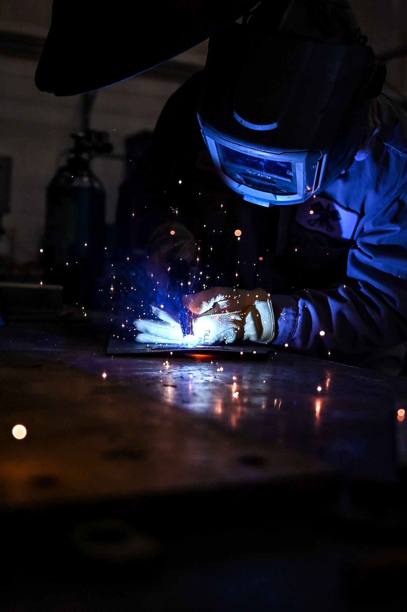 Orlando Cepeda, 90th Logistics Readiness Squadron mobile metal mechanic, welds a piece of metal on F.E. Warren Air Force Base, Wyoming, Nov. 29, 2022. With more than 40 years of experience, the 90 LRS Monster Garage or body shop team is repairing the 90th Missile Wing fleet while supporting the Air Force Global Strike priority of people by finding ways to train the next generation of Airmen and find innovative solutions. (U.S. Air Force photo by Joseph Coslett Jr.)