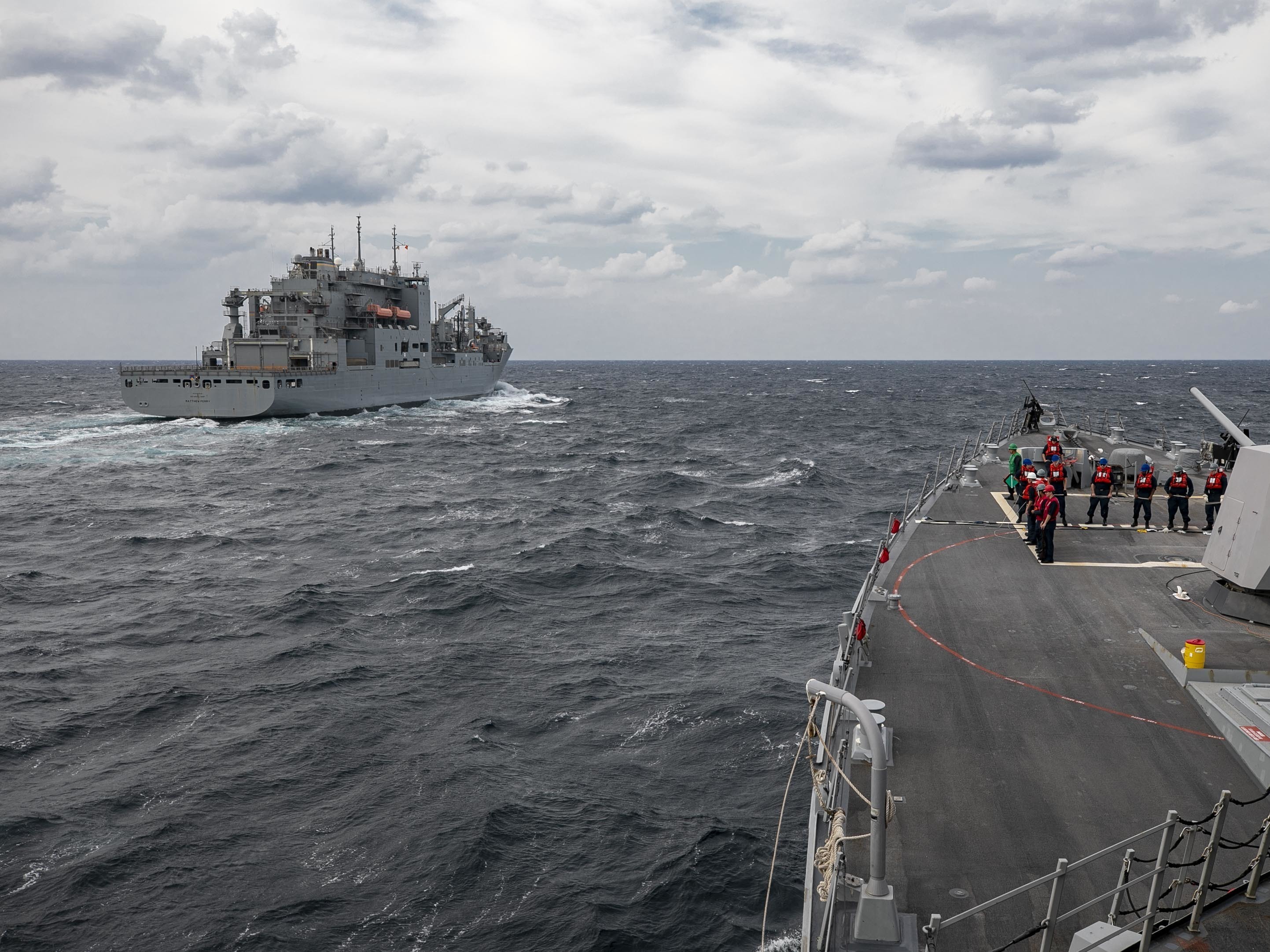 USS Delbert D. Black (DDG 119) approaches USNS Matthew Perry (T-AKE 9) during a replenishment-at-sea.