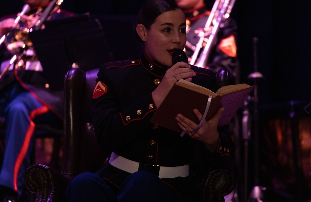 U.S. Marine Corps Lance Cpl. Elizabeth Marino, a vocalist with 2nd Marine Aircraft Wing (MAW) Band, reads “The Night Before Christmas” to the audience during a Christmas concert at Marine Corps Air Station Cherry Point, North Carolina, Dec. 9, 2022. The event was open to the public and was 2nd MAW Band’s first Christmas concert since 2019 due to COVID-19 restrictions. 2nd MAW is the aviation combat element of II Marine Expeditionary Force. (U.S. Marine Corps photo by Staff Sgt. Theodore Bergan)