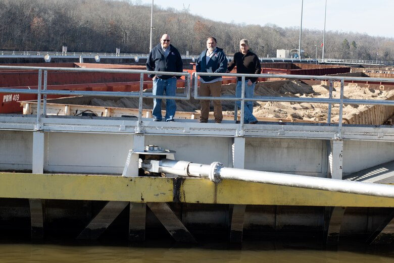 (Left to Right) Joseph Traughber, Jacob Traughber, and Owen Traughber pose together Dec. 12, 2022, at Cheatham Lock on the Cumberland River in Ashland City, Tennessee. All three have served more than 20 years with the U.S. Army Corps of Engineers Nashville District in career fields that support navigation. (USACE Photo by Lee Roberts)