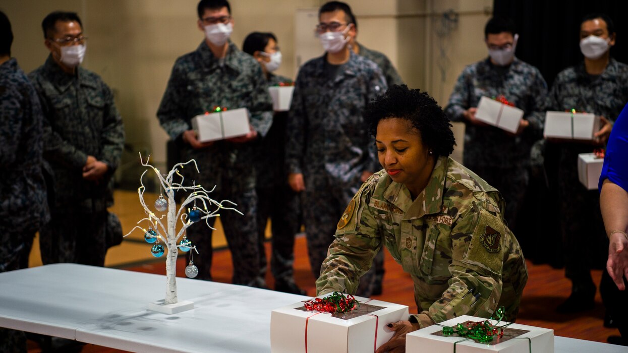 U.S. Air Force Airmen package cookies for delivery during the annual Cookie Caper event at Misawa Air Base, Japan, Dec. 13, 2022. After the cookies were divided and packaged, first sergeants and other volunteers across the base hand-delivered them to their units.