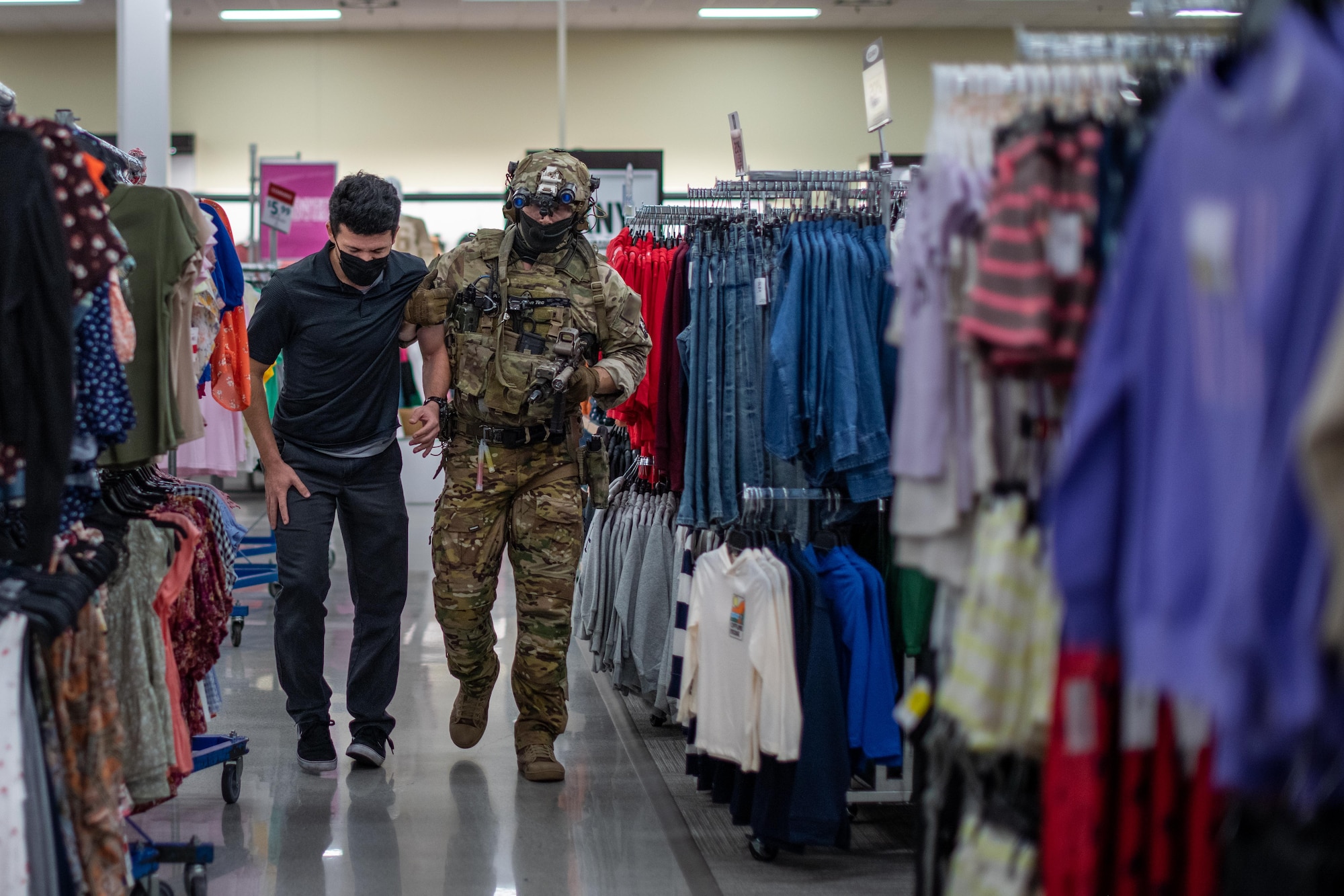 A Soldier assists a simulated hostage.
