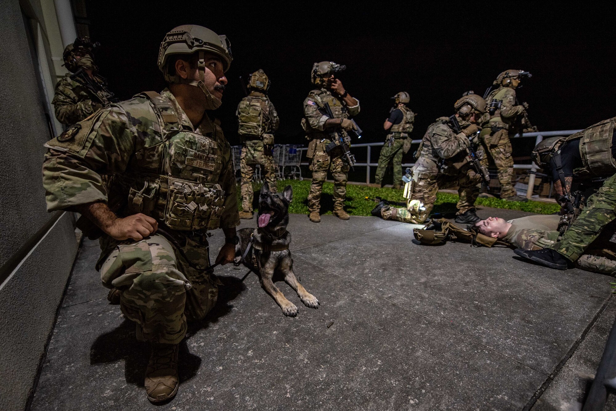 Soldiers and an Airmen apprehend a simulated shooter.