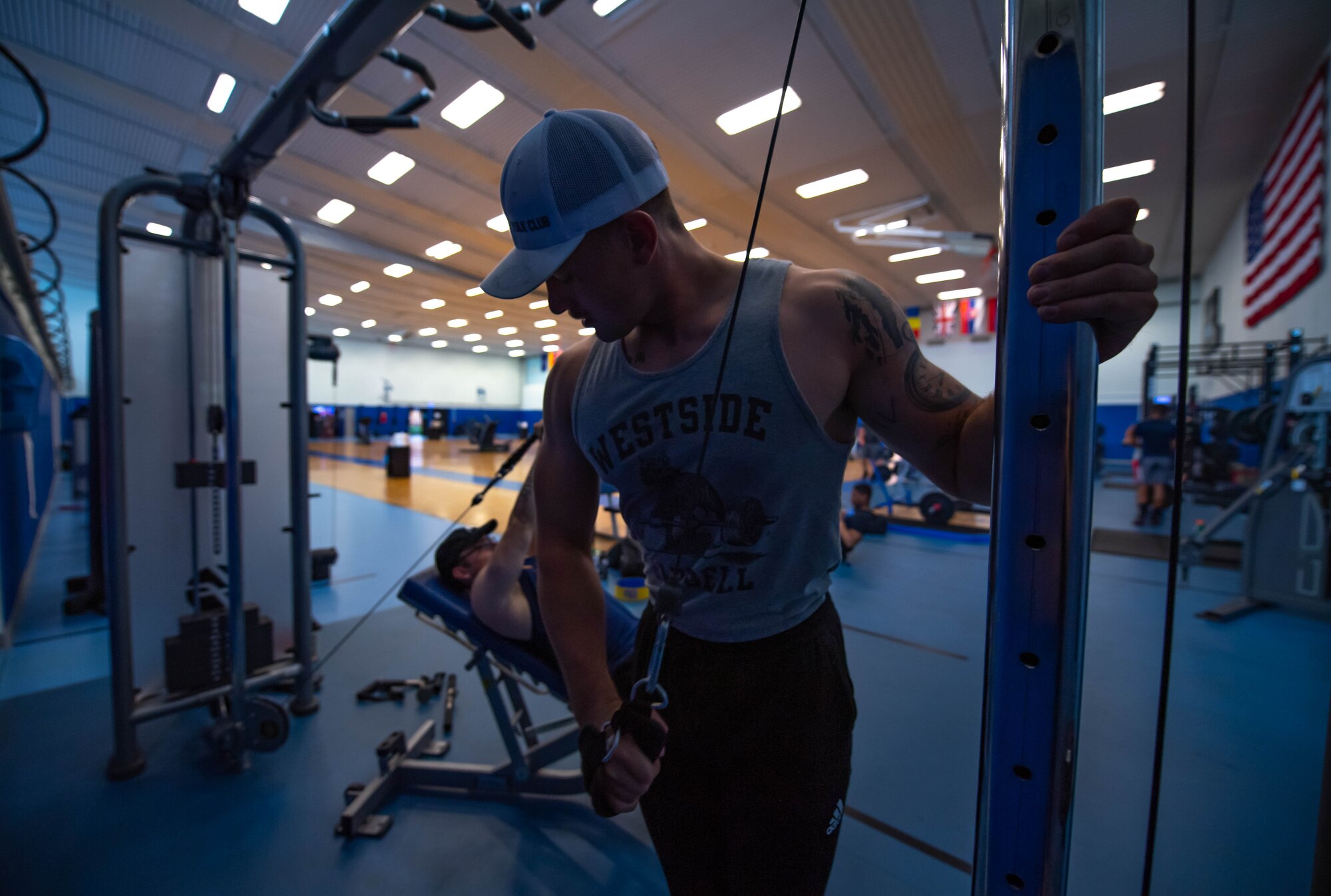 U.S. Air Force Airman 1st Class Tyler Benner, 86th Vehicle Readiness Squadron vehicle operator, exercises at Vogelweh Fitness Center, Germany, July 9, 2021. As a physical training leader for his squadron, Benner works to keep up with his own physical health. Unknown to him at the time, approximately one year later he would face, and survive, an illness that would change his life forever. (U.S. Air Force photo by Airman Jared Lovett)