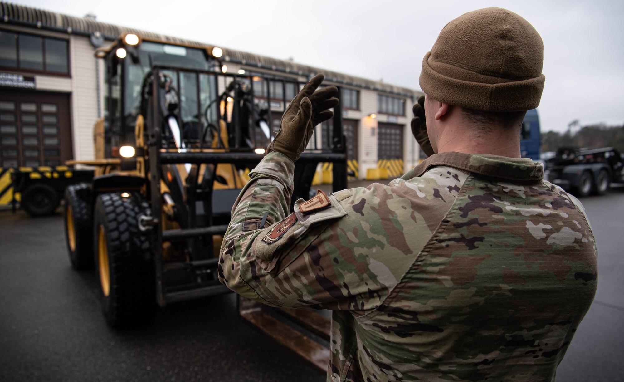U.S. Air Force Airman 1st Class Tyler Benner, right, 86th Vehicle Readiness Squadron vehicle operator, spots for Airman 1st Class Jeremy Evans, left, 86th VRS ground transportation operator, at Ramstein Air Base, Germany, Nov. 30, 2022. Benner was diagnosed with a rare medical condition that resulted in the growth of a baseball-sized abscess in his liver. After several months doctors found the correct treatment for his condition and have kept him on antibiotics ever since while his abscess shrinks and he returns to his regular life. (U.S. Air Force photo by Airman 1st Class Jared Lovett)