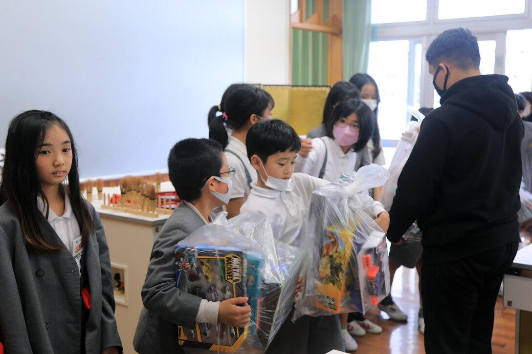 クバサキ高校の士官候補の訓練生が自分たちが集めた沢山のおもちゃを持って北谷町立浜川小学校に訪問し、異文化交流を行いました。