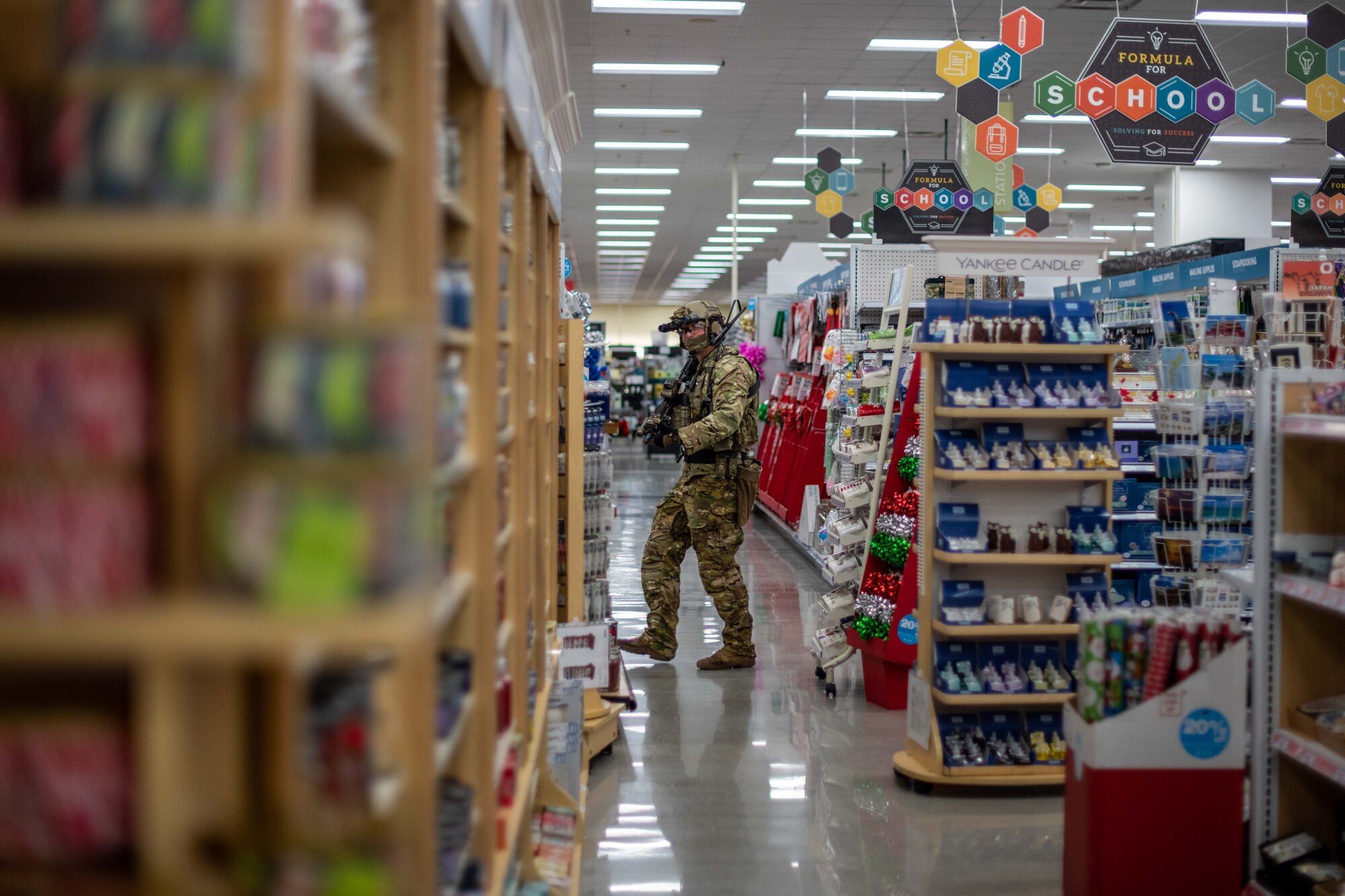 A Soldier checks an aisle.