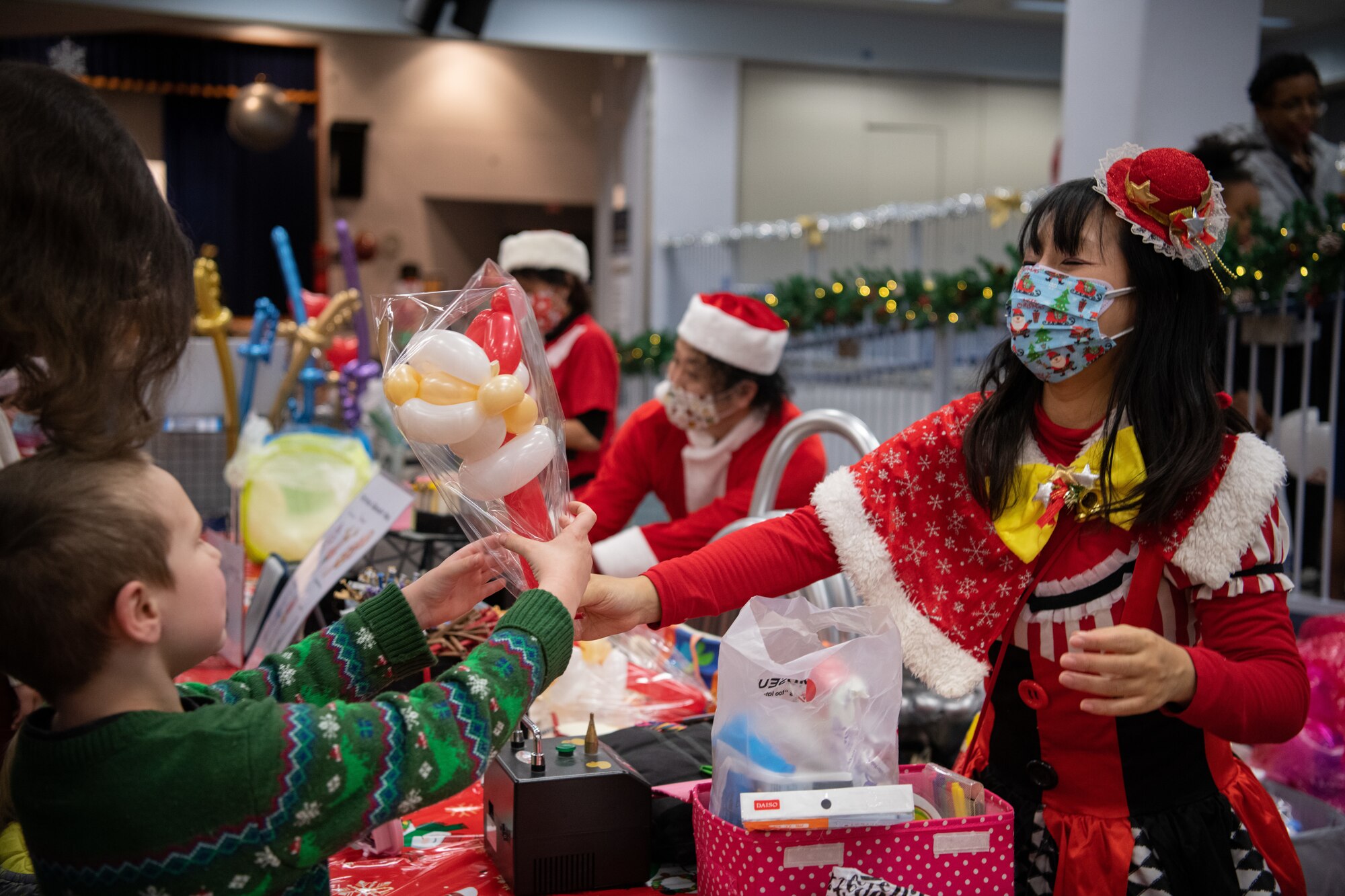 Vendors hand families crafted balloon creations