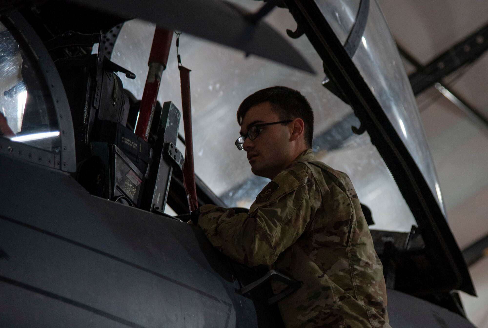 Senior Airman Elijah Gardner, 332d Expeditionary Civil Engineer Programs specialist, looks in the cockpit of an F-15E Strike Eagle as part of "Maintainer for a Day" at an undisclosed location, Southwest Asia, Nov. 25, 2022. "Maintainer for a Day" is a program that allows Airmen from diverse career fields to experience what it’s like to perform maintenance and repair work on an aircraft. (U.S. Air Force photo by: Tech. Sgt. Jim Bentley)