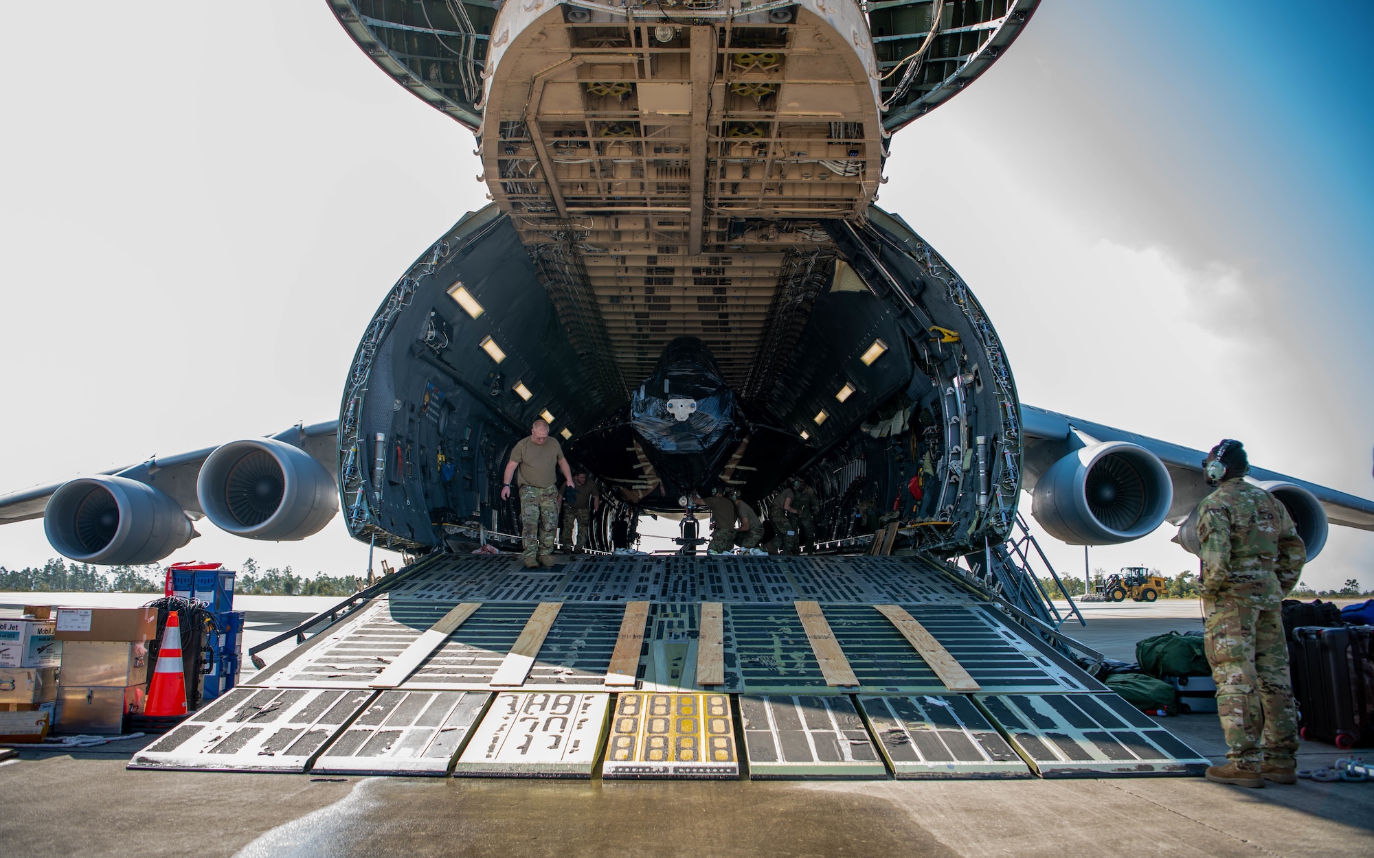 A jet is loaded into a larger air craft.