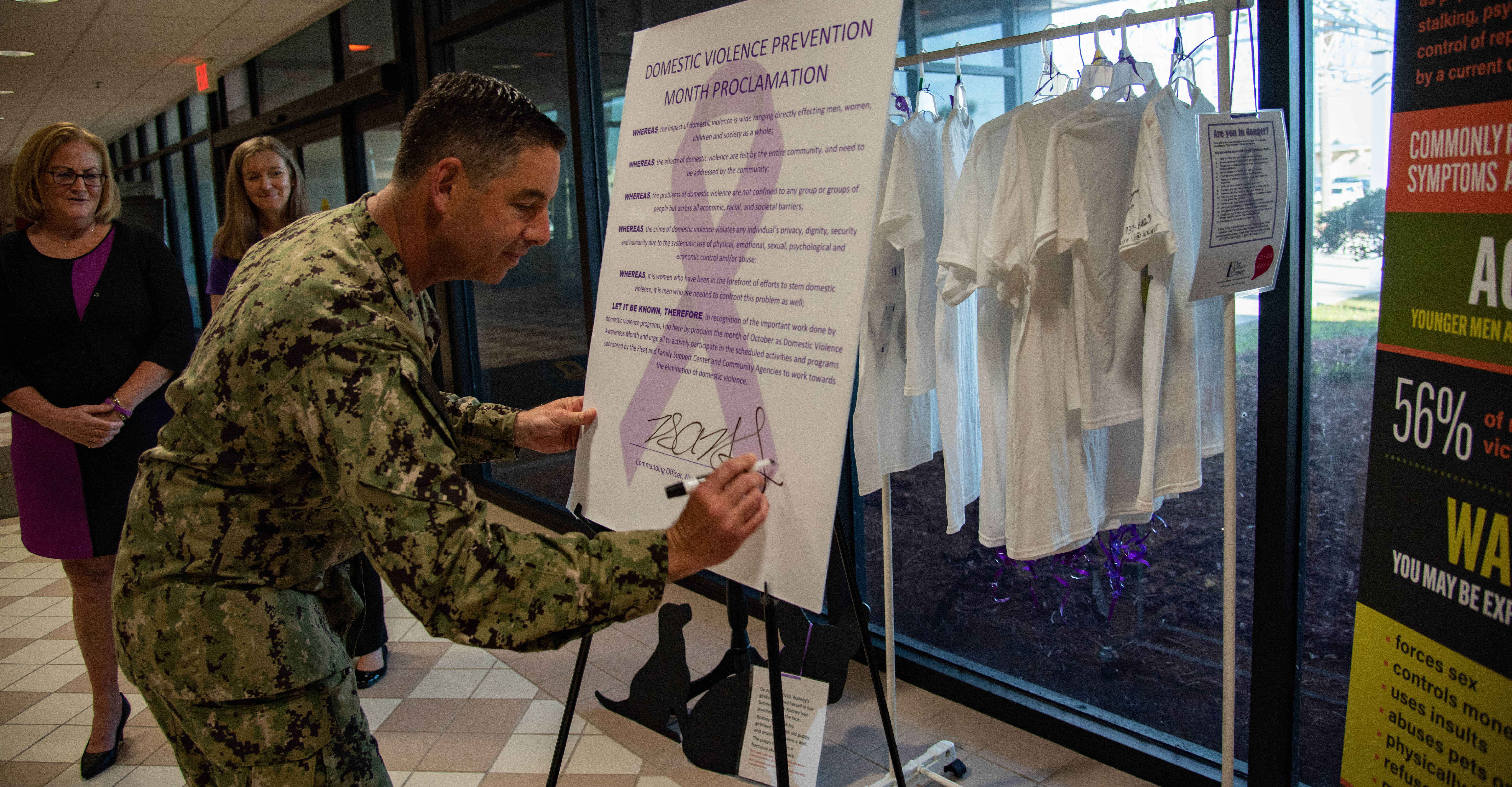 Commanding Officer, Capt. Brian Binder, and Fleet and Family Support Center Mayport staff gather for a Domestic Violence Awareness Month proclamation at  Naval Station Mayport, Florida, Oct. 6, 2022.