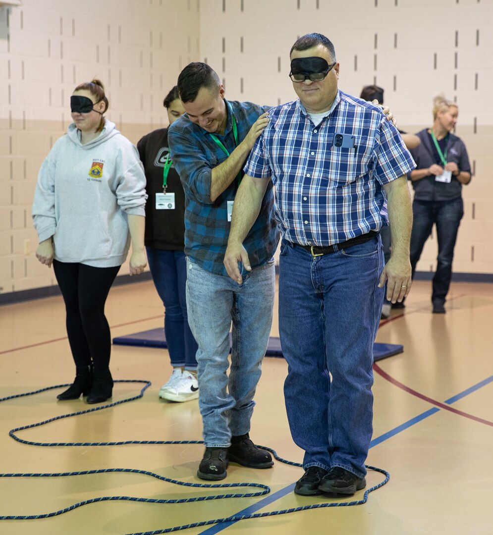 Maj. Brady Lanoue, a chaplain assigned to the Illinois Army National Guard 65th Troop Command, is guided by Air Force Tech. Sgt. Lane Hamm of the Illinois Air National Guard 182d Security Forces Squadron, during a resiliency exercise Dec. 1 on Camp Lincoln in Springfield, Illinois.