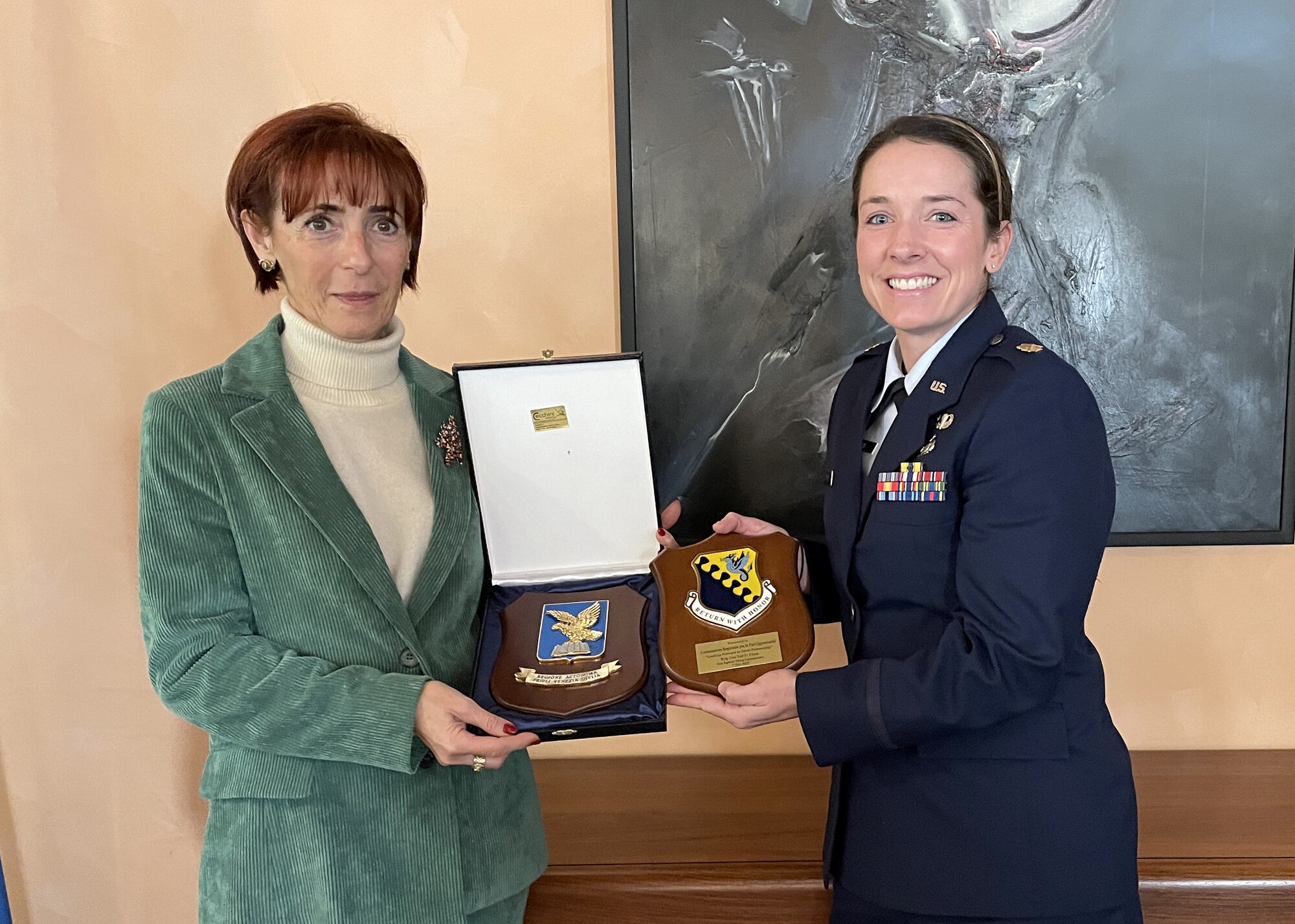 Dr. Dusy Marcolin, President of the Friuli Venezia Giulia region Equal Opportunity committee, and Maj. Kaylee Ausbun, sexual assault response coordinator, exchange plaques and words of gratitude during an exchange program with the FVG region EO board