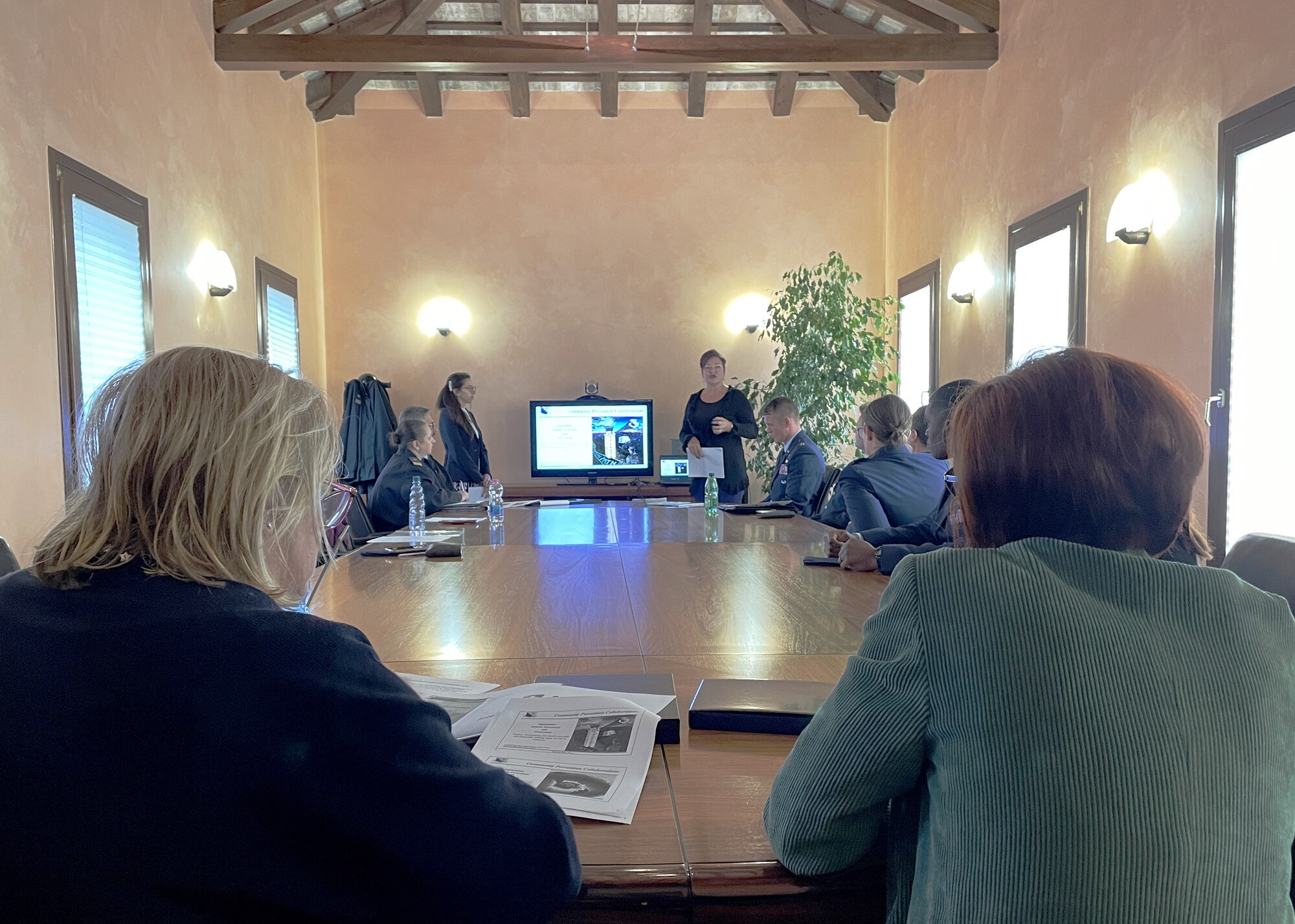 Dr. Cindi Drake, 31st Fighter Wing violence and suicide prevention program manager, and Ms. Marissa Pearl, artist and volunteer, share program practices during an exchange program with the Friuli Venezia Giulia region Equal Opportunity board