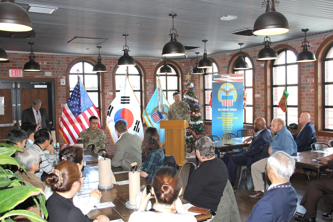 a room full of people watching a speaker at the podium