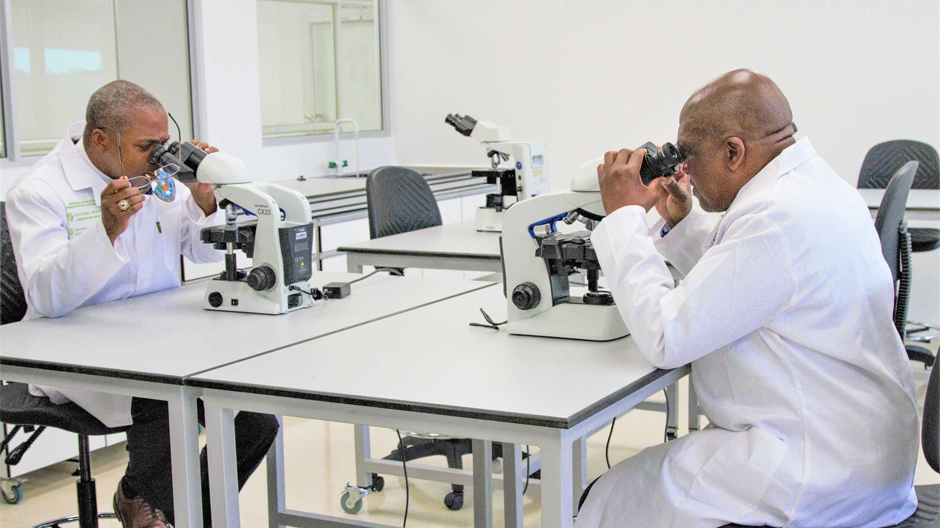 U.S. Ambassador to South Africa Dr. Reuben Brigety II and South African Minister of Health Dr. Joseph Phaahla, use premiere equipment at the Regional Diagnostic Demonstration Center, or Training Center, at South Africa's National Institute for Communicable Diseases in Johannesburg following a commemoration ceremony Dec. 9.