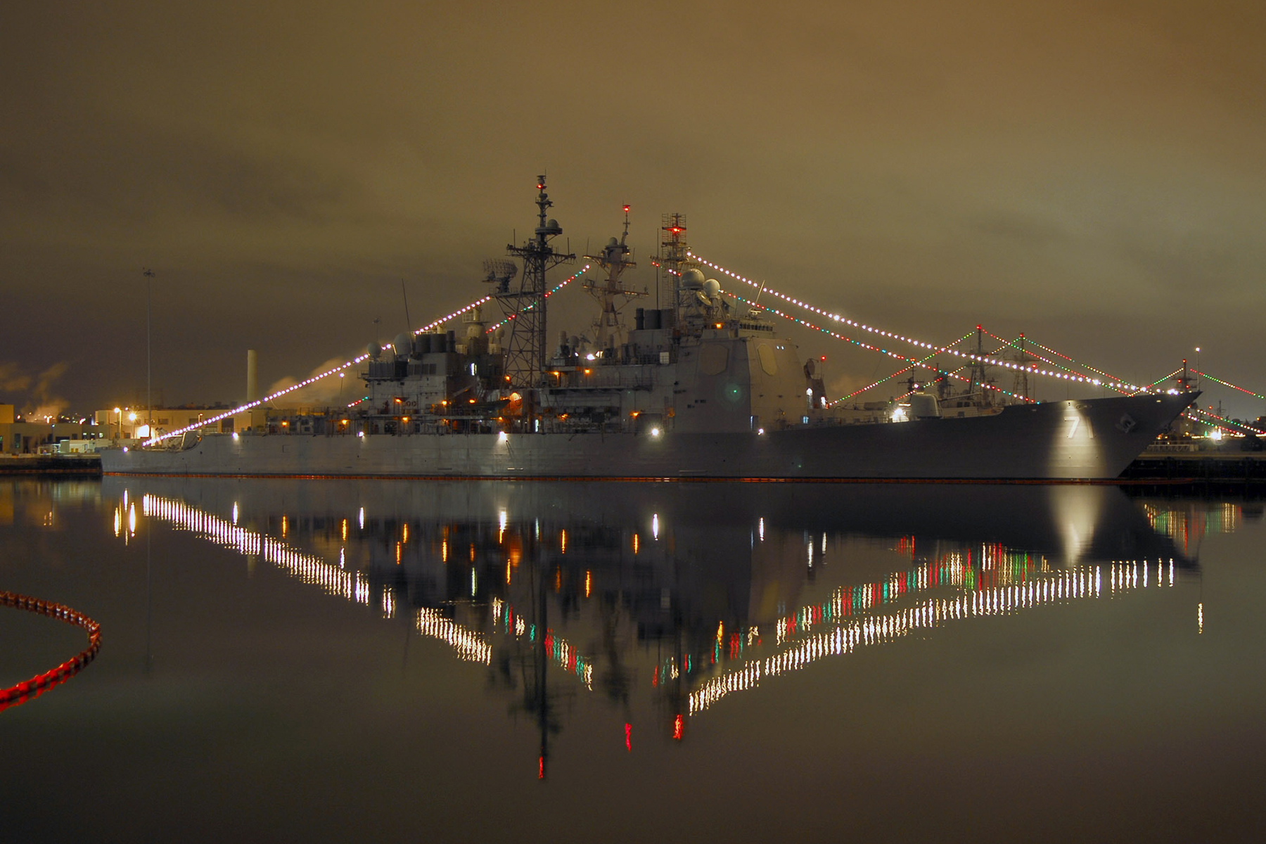 U.S. Navy ship is decorated with holiday lights.