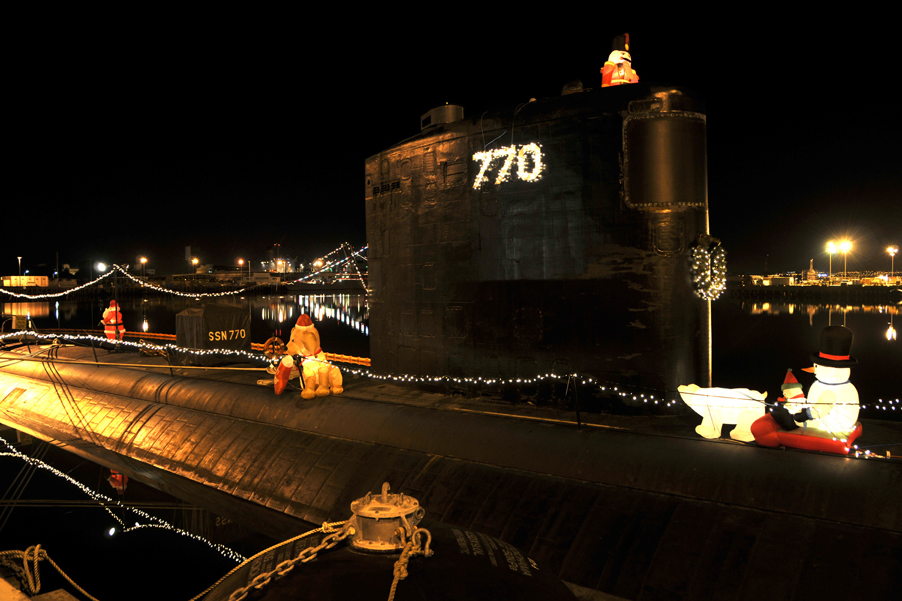 A U.S. Navy submarine is decorated with holiday lights