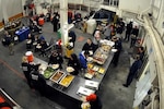 The crew and science team aboard the Coast Guard Cutter Healy conclude a morale day with a cook out in the hangar Sept. 2, 2009.

(U.S. Coast Guard photo by Petty Officer Patrick Kelley)