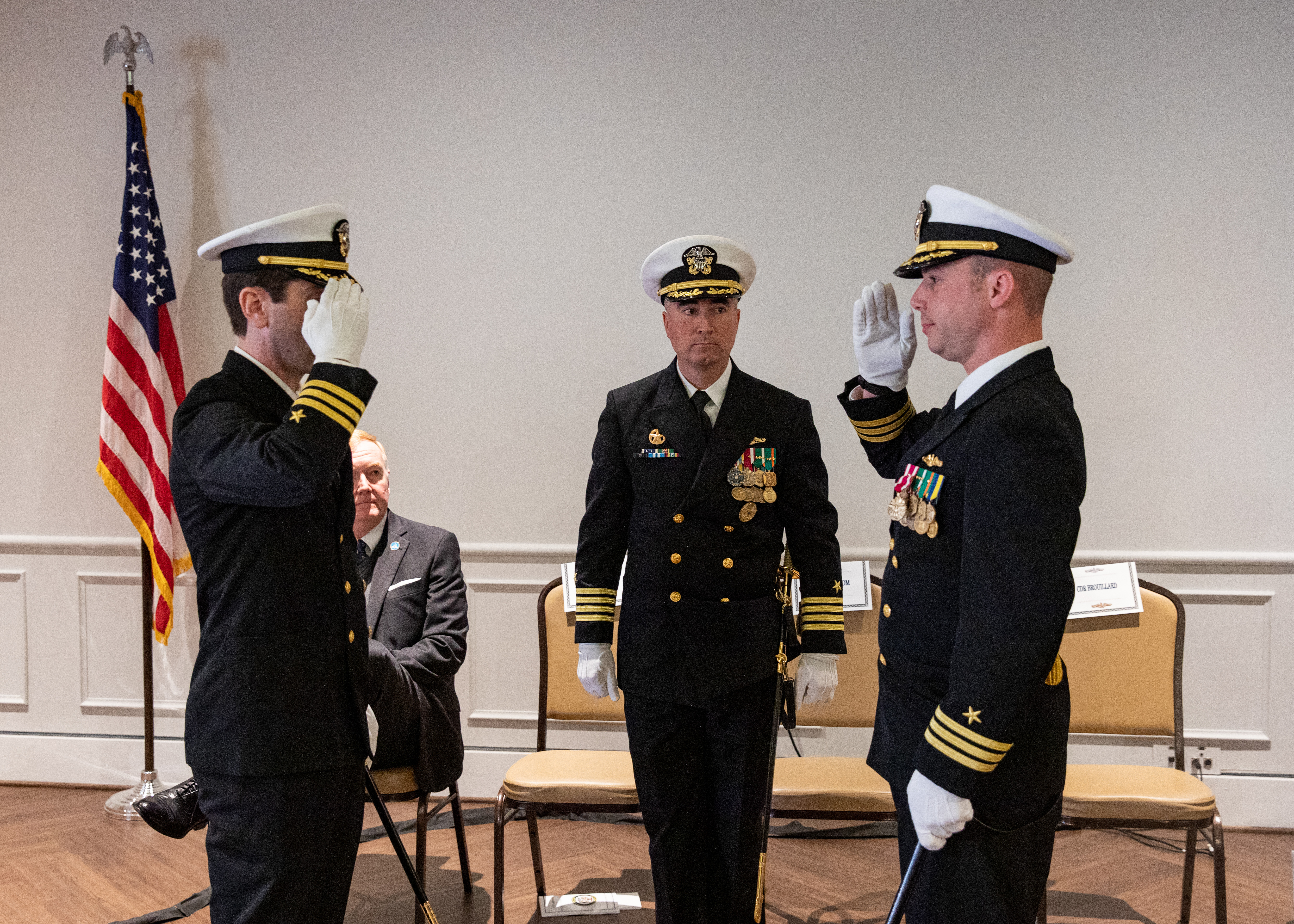 Capt. Brian Hogan, commodore, Submarine Squadron Eight, center, watches as Cmdr. Jonathan Ahlstrom, right, is relieved by Cmdr. Matthew Brouillard, left, during a change of command ceremony for the Los Angeles-class fast attack submarine USS Columbus (SSN 762) at Mariners’ Museum and Park in Newport News, Va., Dec. 14.