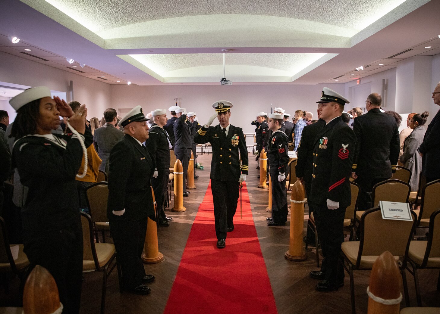 Cmdr. Matthew Brouillard, commanding officer of the Los Angeles-class fast attack submarine USS Columbus (SSN 762) renders a salute to sideways during a change of command ceremony at Mariners’ Museum and Park in Newport News, Va., Dec. 14.