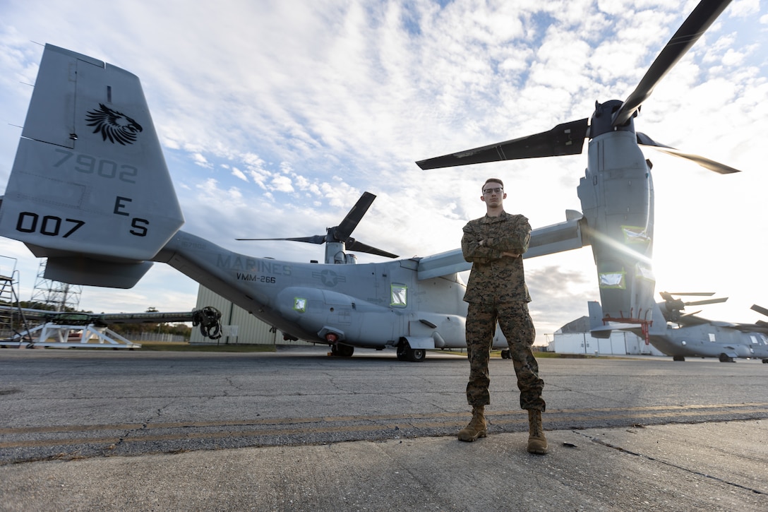 U.S. Marine Corps Lance Cpl. Zachary Keller, an airfield operations supervisor with Headquarters and Headquarters Squadron (H&HS), stands in front of an MV-22 Osprey on Marine Corps Air Station (MCAS) New River, Jacksonville, North Carolina, Nov. 22, 2022. Keller, the recipient of this month’s MCAS New River Go-Getter award, enlisted in the Marine Corps in 2021 from Minonk, Illinois. (U.S. Marine Corps photo by Cpl. Antonino Mazzamuto)